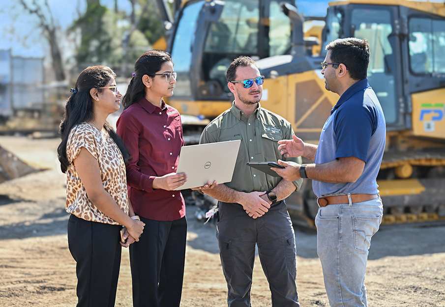 Dr. Vamsi Kalasapudi talking with Sneha Ganupa, Alekhya Seelam and a Petticoat-Schmitt employee