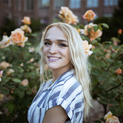 Graduate Assistant Amanda headshot in front of a background of roses
