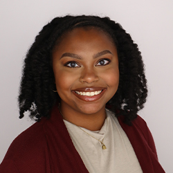 Graduate Assistant Headshot with beige background