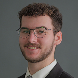 Graduate Assistant Headshot with gray background