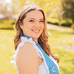 Graduate Assistant Headshot with field background