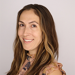 Director Headshot with beige background 