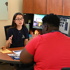 higher ed student talking to advisor