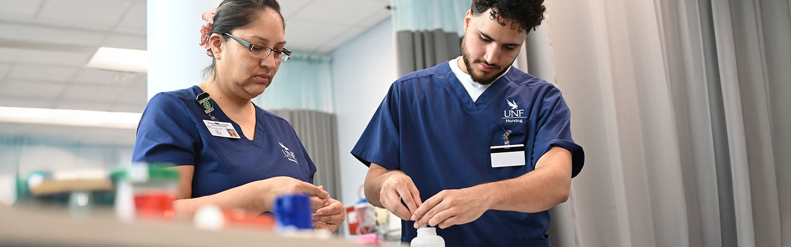 two nursing students mixing medications