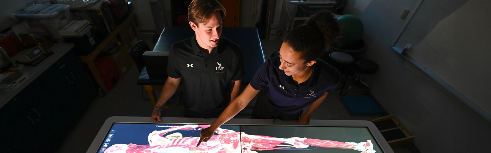 two students viewing the muscles in a body on the Anatomage table