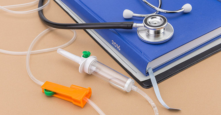 blue book stethoscope and iv tubing on a table