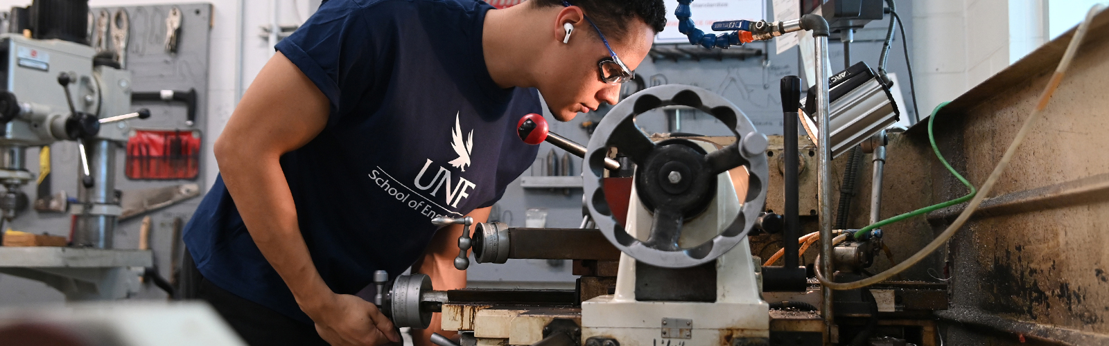student working on metal machine