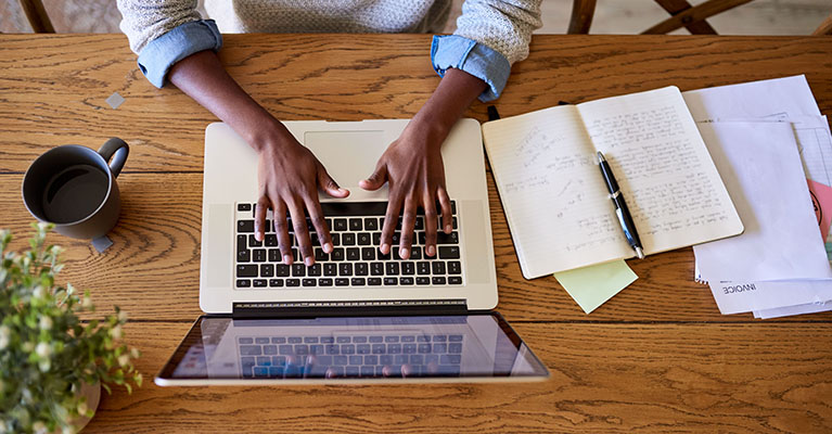 person typing on a laptop at a desk