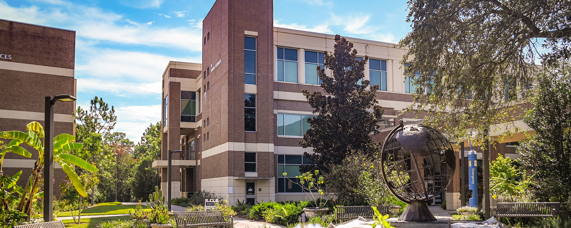 social sciences building with globe and plaza in front
