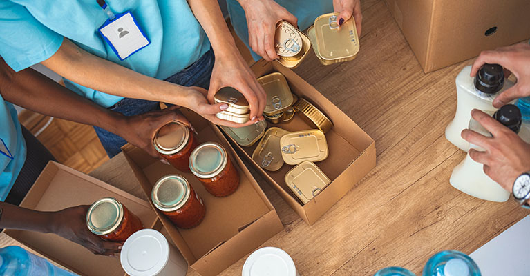 volunteers boxing up food for a drive
