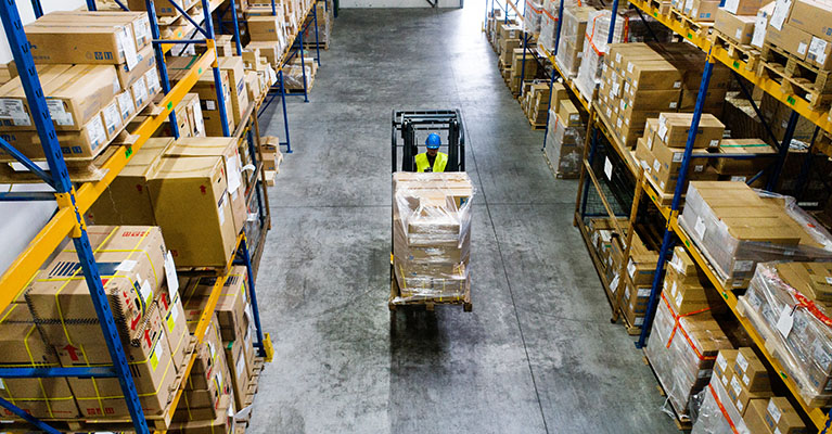 driver and forklift in a warehouse