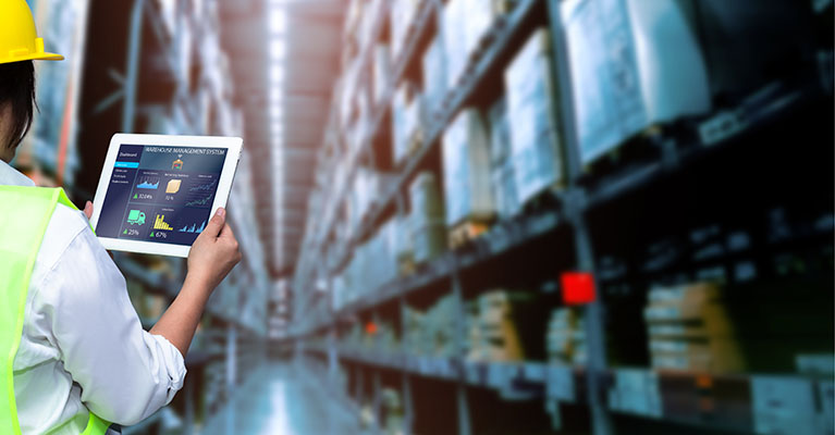 worker using a tablet to document inventory at a warehouse