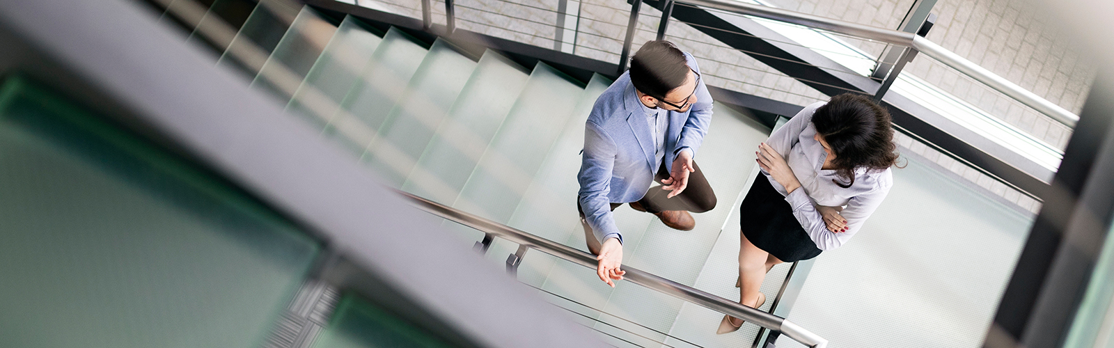two people on a staircase talking