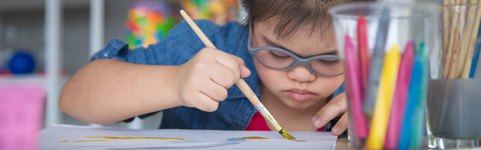 a student painting on a piece of paper