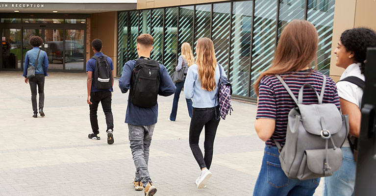 students walking into a high school