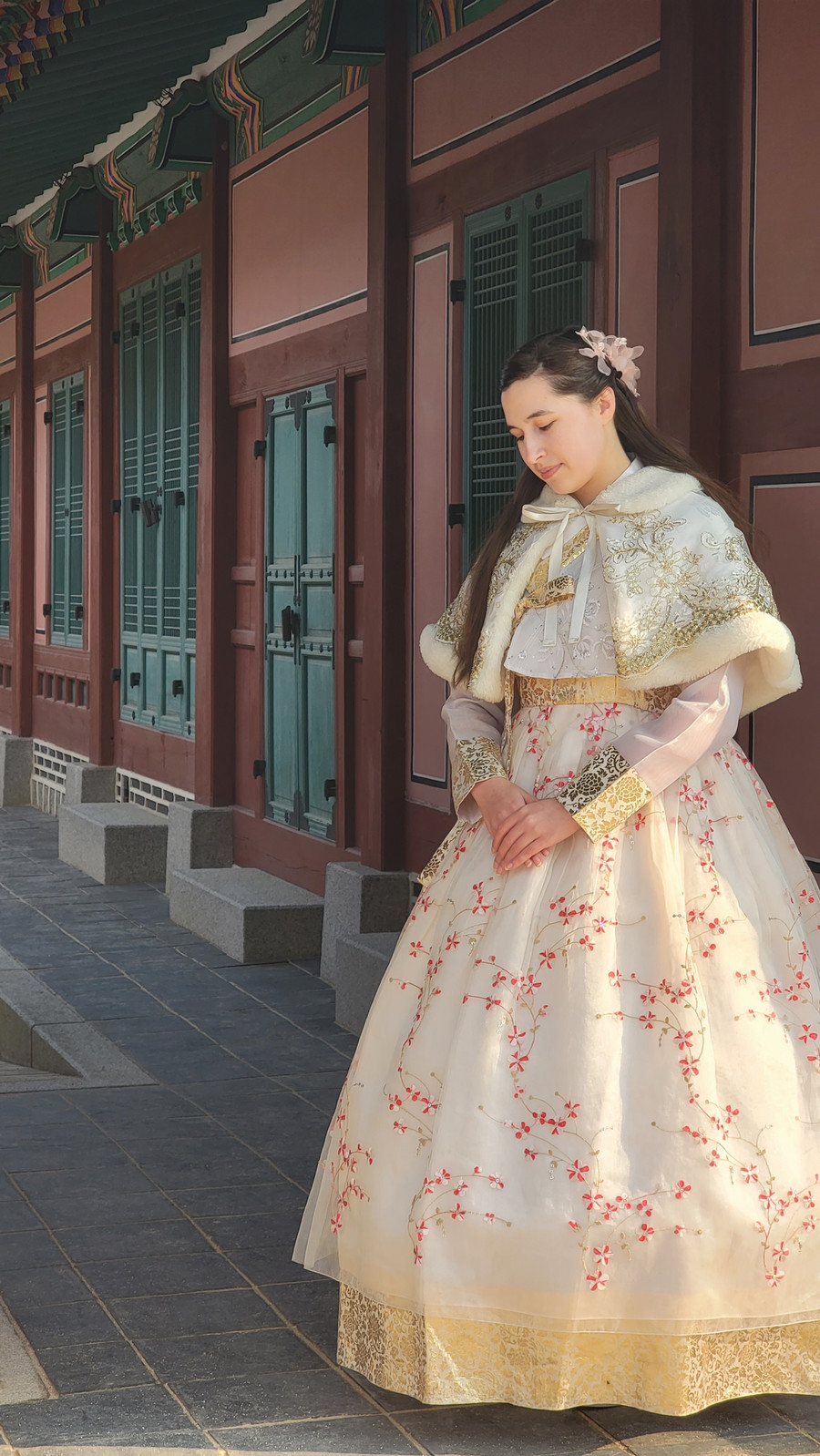 Darryn Bone wearing a gold embroidered Korean Hanbok.