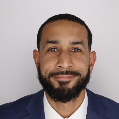 Emmanual Lambright in front of white backdrop