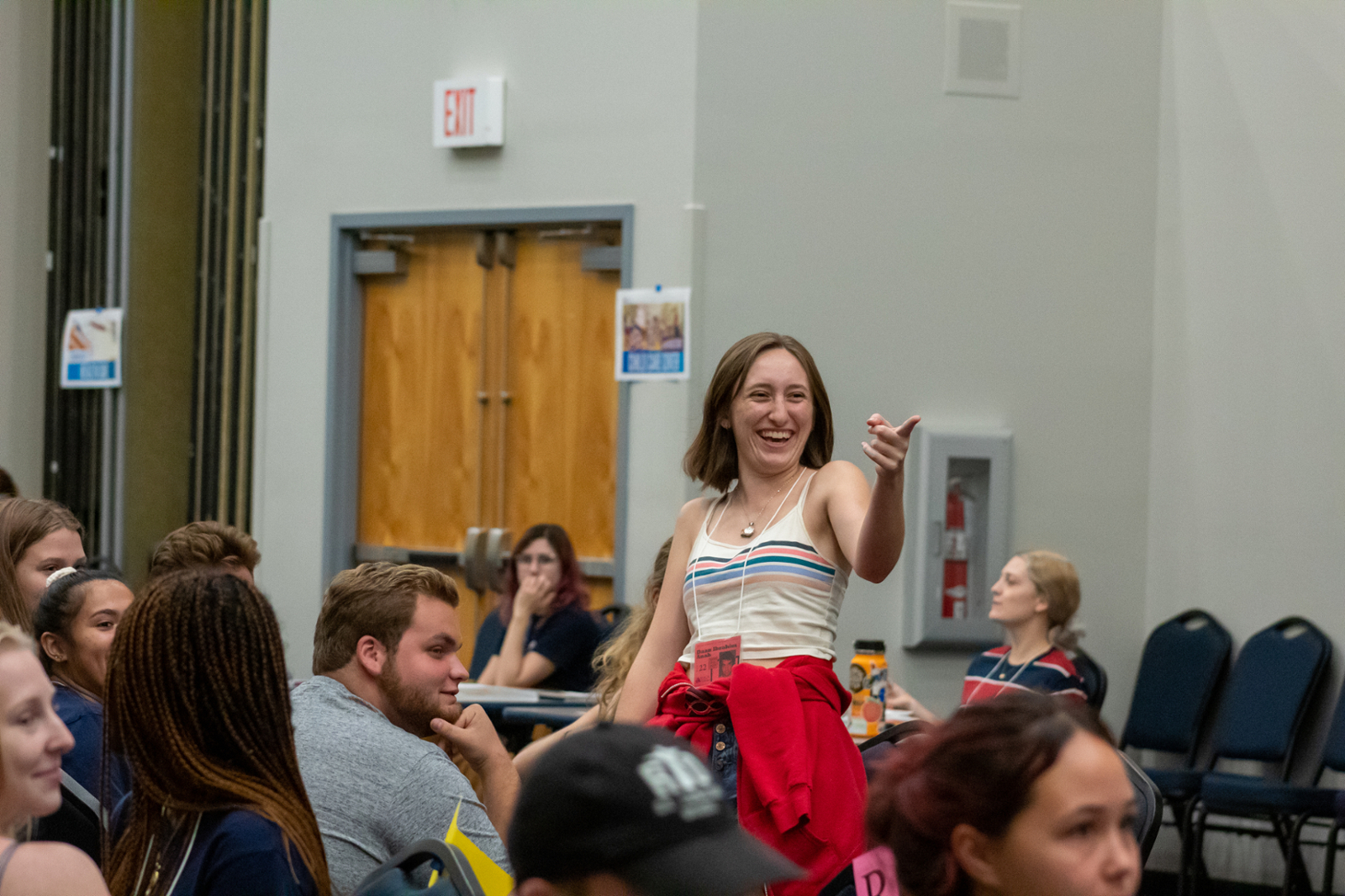 Student smiling and pointing during Refugee Simulation