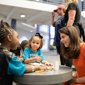 Honors student working with refugee children for Honors Colloquium course