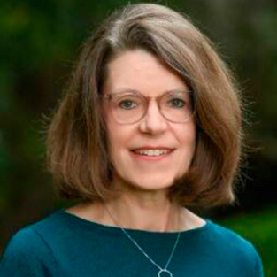 Headshot of woman wearing glasses and blue top. 