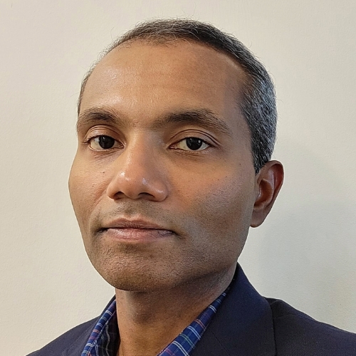 Indika Kahanda in front of a white backdrop