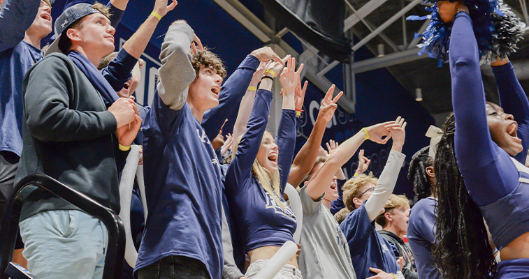students cheering on the UNF basketball team