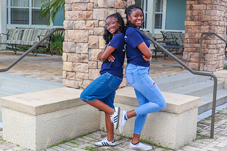 Two residents back to back smiling