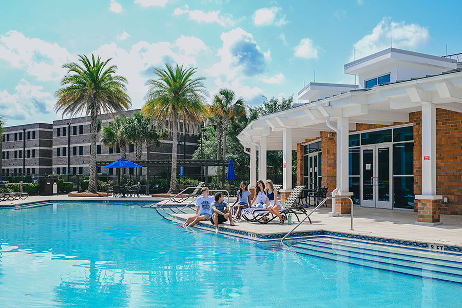 Osprey Clubhouse on a gorgeous UNF day with UNF students in the pool