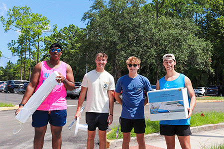 Movers and Groovers helping move residents into their rooms