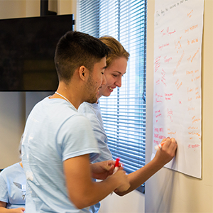 llc residents writing goals and smiling 