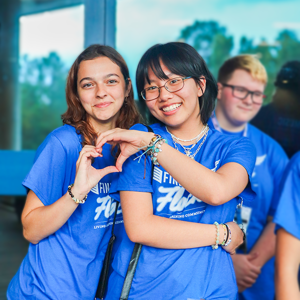 UNF LLC residents smiling and making a heart with their hands