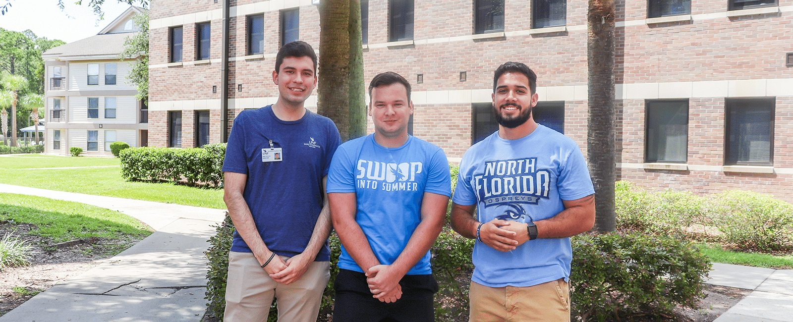 three male residents posing together