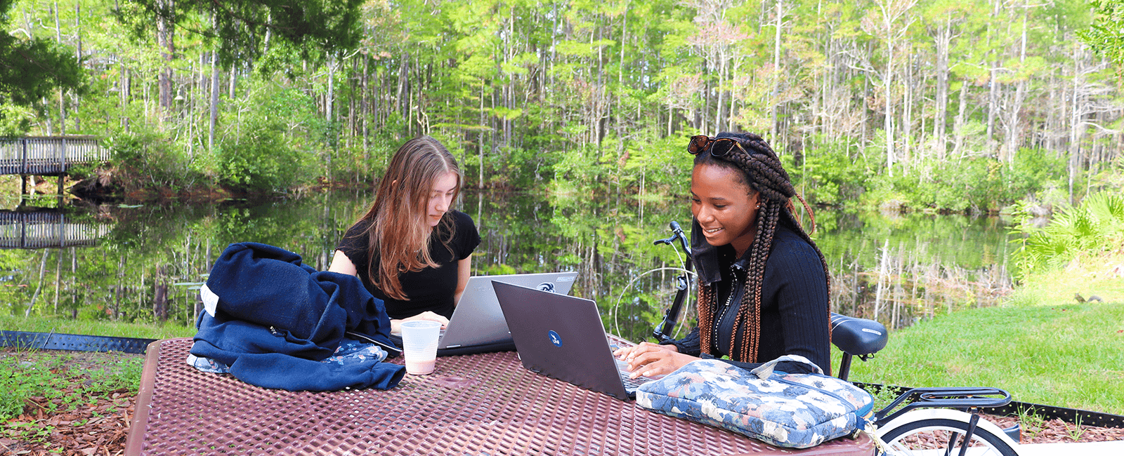 two residents studying outside of the residence halls on a gorgeous day