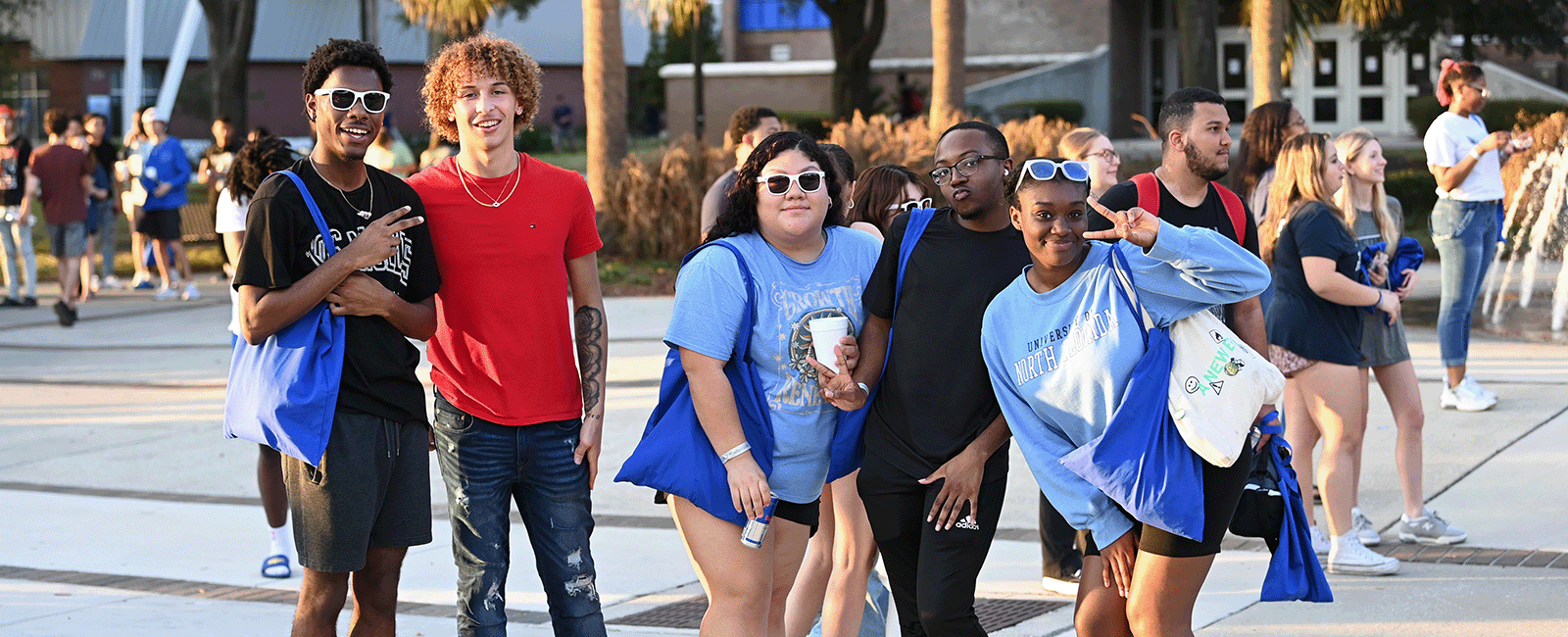 students smiling and posing on UNF campus
