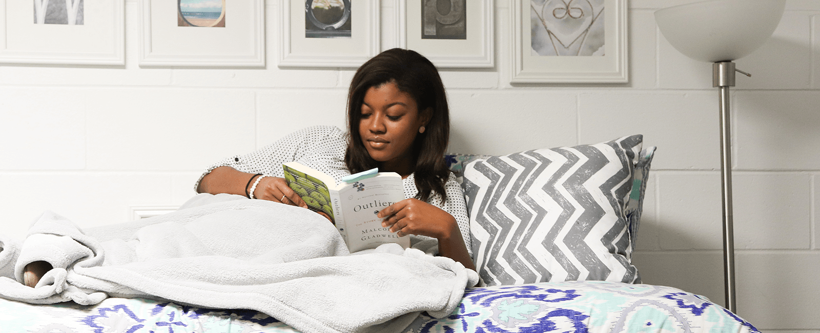 resident reading a book in bed in osprey landing