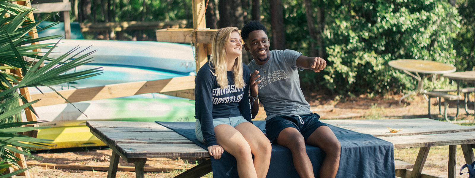 two unf students on unf campus on a bright day