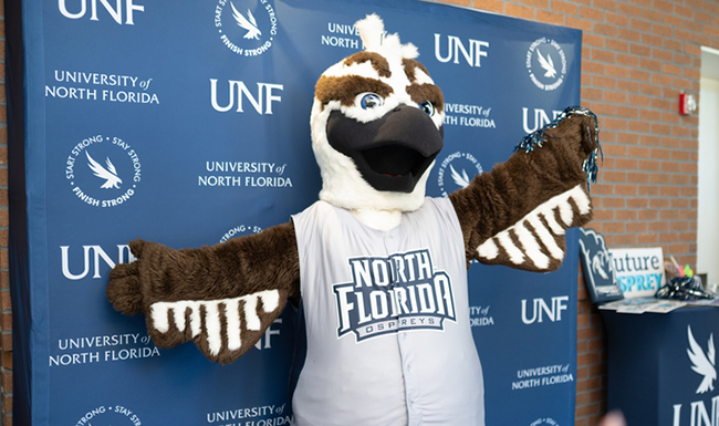 Ozzie Osprey in front of UNF backdrop