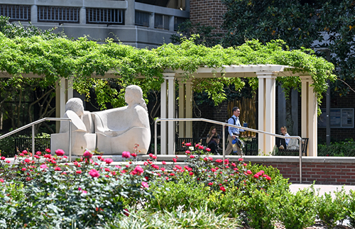 statute on unf campus with flowers