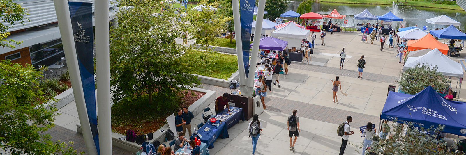 Students gathered around tent setups outside the John A. Delaney Student Union