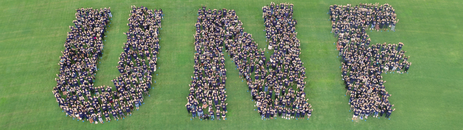 faculty and staff forming the letters u n f