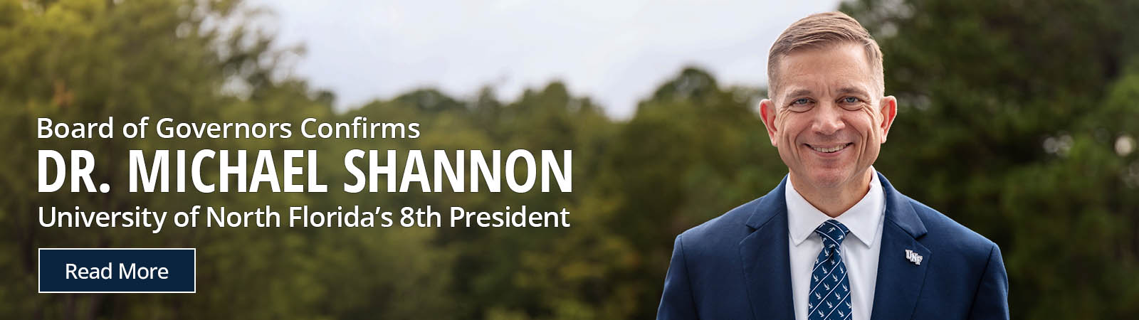 Board of Governors confirms mr michael shannon as unf's 8th president with him standing outside.