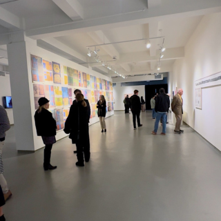 People looking at art on a wall in an art gallery