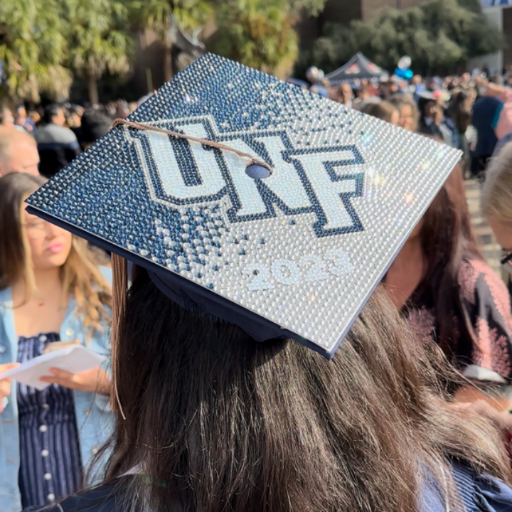 A graduation cap that says "UNF" that is bedazzled