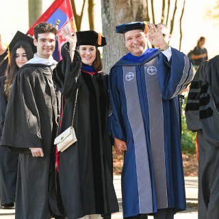 UNF's president, Dr.Limayem, wife, and son, wave and smile towards camera. 