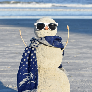 Snowman made out of sand with a UNF scarf on. 