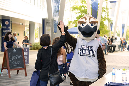 Ozzie high-fives a student