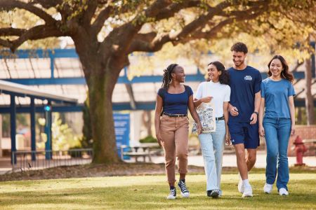 Four students walking together on campus
