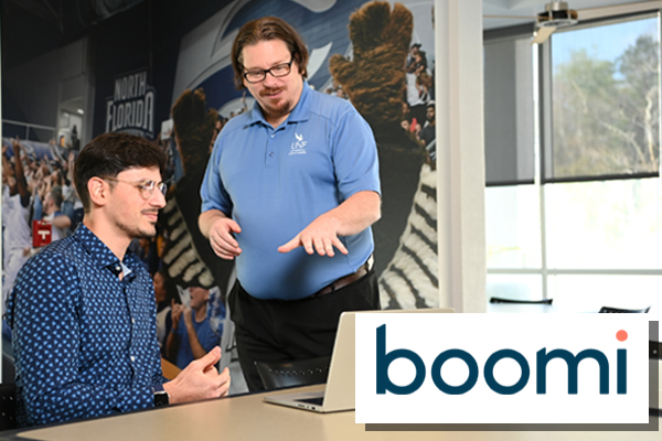 UNF employees at a laptop excited about boomi