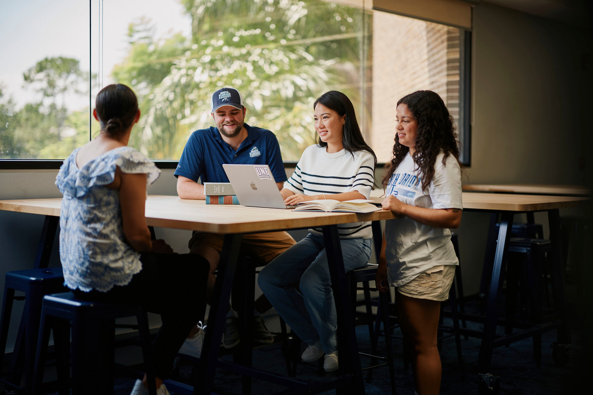 Students working around a laptop