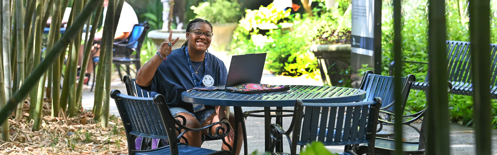 Student with a laptop in the bamboo forest